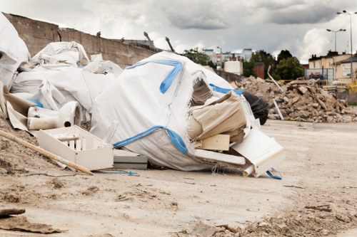 Supervisor reviewing safety practices during waste removal work